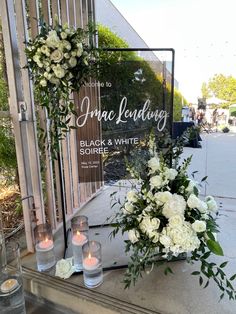 flowers and candles are placed in front of the entrance to an event