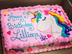 a pink birthday cake with a unicorn on it