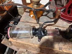 an old fashioned water bottle sitting on top of a wooden table