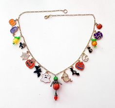 This happy and colorful Halloween charm necklace is handcrafted by myself and a one of a kind original.  The gold plated chain is 20 inches long with 17 drops containing  pumpkins, jack o lanterns,  a moon, bats and crystals so it sparkles as you move.  It contains an assortment of enamel charms, glass, acrylic and crystals.  If you need it shorter or longer just let me know, and I will adjust it to as close as possible to the size you desire. If you would like a charm switched to something else just ask!  Each charm is placed with thought  for color and balance.  It is  a really fun piece, and sure to make you smile for years to come. If you have any questions, please ask.  I do my best to describe items accurately. If something wouldn't be right it would be by accident.  Please let me kn Themed Handmade Gold Necklaces, Themed Handmade Multicolor Necklace, Handmade Dangle Necklaces For Halloween, Handmade Spooky Necklace For Halloween, Unique Nickel-free Necklaces For Halloween, Halloween Pendant Necklaces With Adjustable Chain, Handmade Spooky Halloween Necklaces, Halloween Dangle Metal Necklaces, Silver Charms Necklace For Halloween