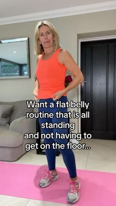 a woman is standing on a pink mat with her hands in her pockets and the words, want a flat belly routine that's all standing and not having to get on the floor