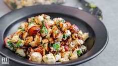 a black bowl filled with food on top of a table