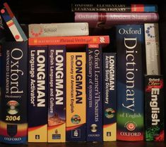 a bunch of books that are sitting on a book shelf in front of each other