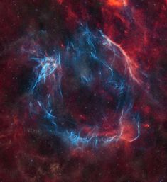 an image of a very bright blue and red star in the middle of some space