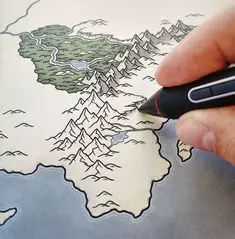 a person is drawing a map with a pen and inking it on the paper