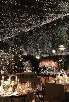 the tables are set with candles, flowers and greenery for an elegant wedding reception