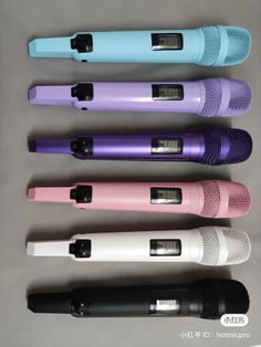 five different colored microphones lined up in a row