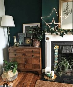 a living room filled with furniture and a fire place covered in greenery next to a fireplace