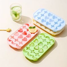 three heart shaped ice trays sitting next to each other on top of a table