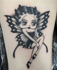 a girl with a butterfly tattoo on her thigh