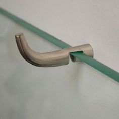 a close up of a metal handle on a white wall with green tape around it