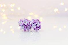 Dainty lilac flowers studs earrings.  The flowers are handmade by me from polymer clay. The petals of the flowers are flexible, yet strong and do not break, they look like a natural. The base of the carnation earrings are made of stainless steel. These earrings feature delicate lilac flowers that are meticulously crafted to capture every intricate detail. Our commitment to realism is evident in every petal and the lush bouquet of lilacs creates a truly captivating piece. Our earrings are handcrafted with high-quality polymer clay, ensuring that each flower has a strong structure while remaining flexible to the touch. You can feel the quality and craftsmanship as soon as you hold them in your hands. To ensure comfort, we use stainless steel as the base of the post stud earrings. This makes Lilac Earrings, Romantic Earrings, Elegant Bouquet, The Embrace, Lilac Flowers, Studs Earrings, Lilac Color, Hypoallergenic Earrings, Little Flowers