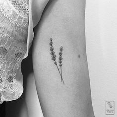 a single flower tattoo on the left arm and shoulder, with small flowers in it