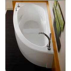 an oval shaped bathtub sits in the corner of a bathroom