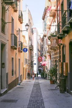 an empty street with people walking down it