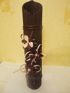 a decorative vase made out of chocolate and ribbon