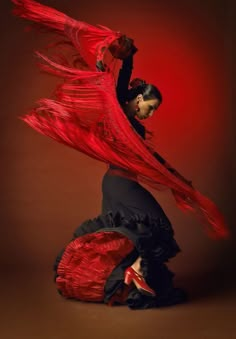 a woman in black and red is dancing