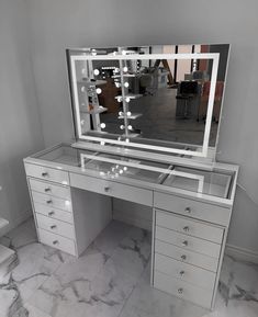 a mirrored desk with drawers and a large mirror