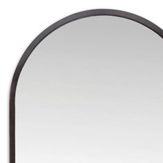 an arched mirror is shown against a white wall with black trimmings and a dark wood frame