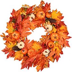 a wreath with autumn leaves and pumpkins