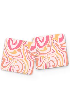 two pink and yellow coasters with swirl designs