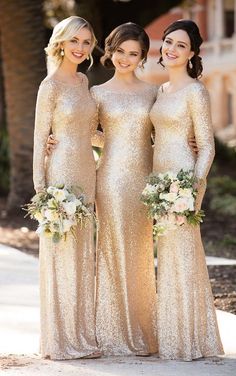 three women in gold dresses standing next to each other