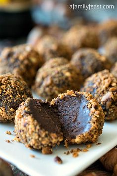 chocolate truffles on a white plate with nuts