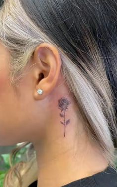 a woman with a tattoo on her left ear