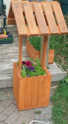 a wooden planter with flowers in it