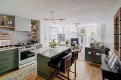 an open kitchen and living room with wood floors