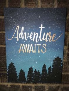 an adventure awaits painting on a brick wall with trees in the foreground and stars in the background