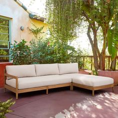 a white couch sitting on top of a patio