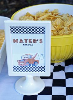 a table topped with a bowl of chips next to a plate filled with cheetos