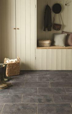 a room that has some shoes on the floor and a basket in front of it