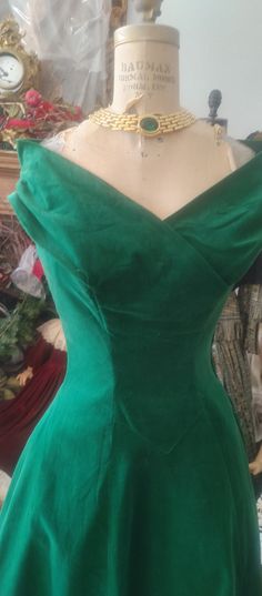 Stunning velvet 1950 dress. good condition.   dark green.  portiat neckline.  beautifully made.  collar has shoulder freature with the tip of collar raised upward to flatter shoulders.   slight flair to skirt.  ptincess styling.  Back has velvet flap over.  size 5-7.   very good condition.  necklass not included.   no refunds Dark Green Fitted Formal Dress, Dark Green Fitted Dress For Formal Occasions, Fitted Green Velvet Dress, Elegant Fitted Green Velvet Dress, Green Vintage Formal Dress, Vintage Green Formal Dress, Green Velvet Dress For Formal Occasions, Vintage Velvet Dress With Fitted Bodice, Green Holiday Dress