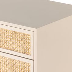 a close up of a drawer with wicker on the top and bottom drawers in white