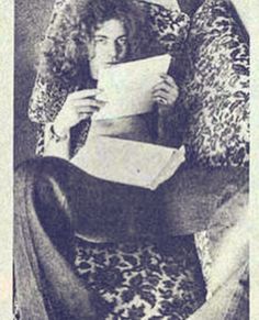 an old black and white photo of a woman reading