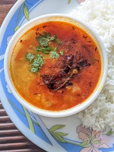 a bowl of soup and rice on a plate