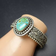 "VINTAGE NAVAJO BRACELET DESCRIPTION: Heavy gauge hand-stamped sterling silver band adorned with a gorgeous specimen of Royston turquoise, this impressive bracelet will be a cherished addition to your collection of fine vintage Native American jewelry. MEASUREMENTS: Interior of the cuff measures 5 1/8\" with an additional 7/8\" non-adjustable gap. Total circumference: 6\" Measures 2 1/8\" straight across the widest part (from wrist bone to wrist bone) Band measures 1/2\" wide Cabochon measures 1 Vintage Turquoise Stamped Cuff Bracelet, Vintage Turquoise Stamped Bracelets, Vintage Sterling Silver Stamped Bangle, Vintage Stamped Sterling Silver Cuff Bracelet, Silver Patina Cuff Bracelet As A Gift, Vintage Sterling Silver Stamped Cuff Bracelet, Vintage Silver Bracelets Hand Stamped, Silver Cuff Bracelet With Patina As Gift, Vintage Adjustable Cuff Bracelet Hand Stamped