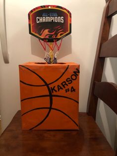 an orange box with a basketball on top of it