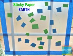 sticky paper earth on a window sill with blue and green squares in the middle