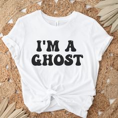 "I'm a ghost - perfect lazy halloween costume  Size of text and image will vary depending on the size of the shirt. Text color will be the same as indicated on the color charts.  If you would like something different or would like specific information, please feel free to message me! Sizing: Unisex. All measurements are taken while the shirts are lying flat. Width is measured across the chest (under arm to underarm). Length is measured from shoulder to the bottom of the shirt. We recommend sizing up fora roomier fit (t-shirts are  generally true to size. Made with Bella canvas t-shirts.  T-shirts Approximately: (Size up for a roomier fit- T-shirts typically fit true to size) Small: 18\" W x 28\"L Medium: 20\" W x 29\" Large: 22\"W x 30\" L XL: 24\" W x 31\" L 2XL: 26\" W x 32\" L 3XL: 28\" White Horror T-shirt With Letter Print, Halloween Costume Last Minute, Costume Last Minute, Funny Halloween Tshirt, Halloween Costume Funny, Last Minute Halloween Costume, Lazy Halloween Costumes, Ghost Tshirt, Lazy Halloween