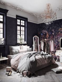 a bedroom with black walls, white furniture and a chandelier hanging from the ceiling