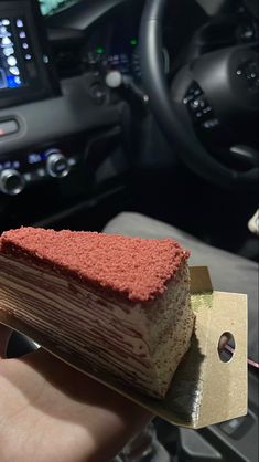 a piece of cake sitting on top of a wooden block