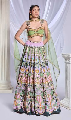 A green sequin-printed lehenga featuring pockets, adorned with gold chains, crystals, pearls and heart-shaped metal accents. It is paired with a green organza blouse, embroidered with gold chains, pearls, glass stones and beads, along with an asymmetrical organza dupatta with a pearl border and sequin scatter. Green Silk Sets For Reception, Green Hand Embellished Traditional Sharara, Green Designer Party Wear Sets, Festive Green Silk Lehenga, Festive Green Hand Embellished Choli, Anarkali Green Lehenga With Sequins, Green Hand Embellished Dupatta In Traditional Drape, Bollywood Style Hand Embellished Green Sharara, Hand Embellished Green Bollywood Sharara