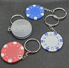 four different colored poker chip keychains with the word off written on one of them