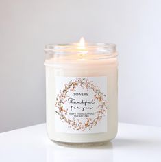 a candle that is sitting on top of a white surface with the words, no one is