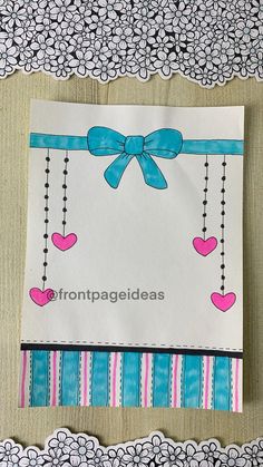 a piece of paper with a bow and hearts on it