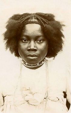 an old photo of a woman with large afros and braids on her hair