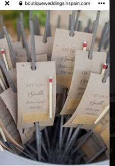 there are many small tags attached to clothes pins in a bucket with toothpicks